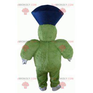 Mascote monstro verde peludo e gordo muito sorridente -