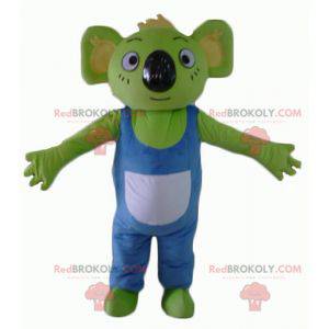 Mascota koala verde con overoles azules y blancos -