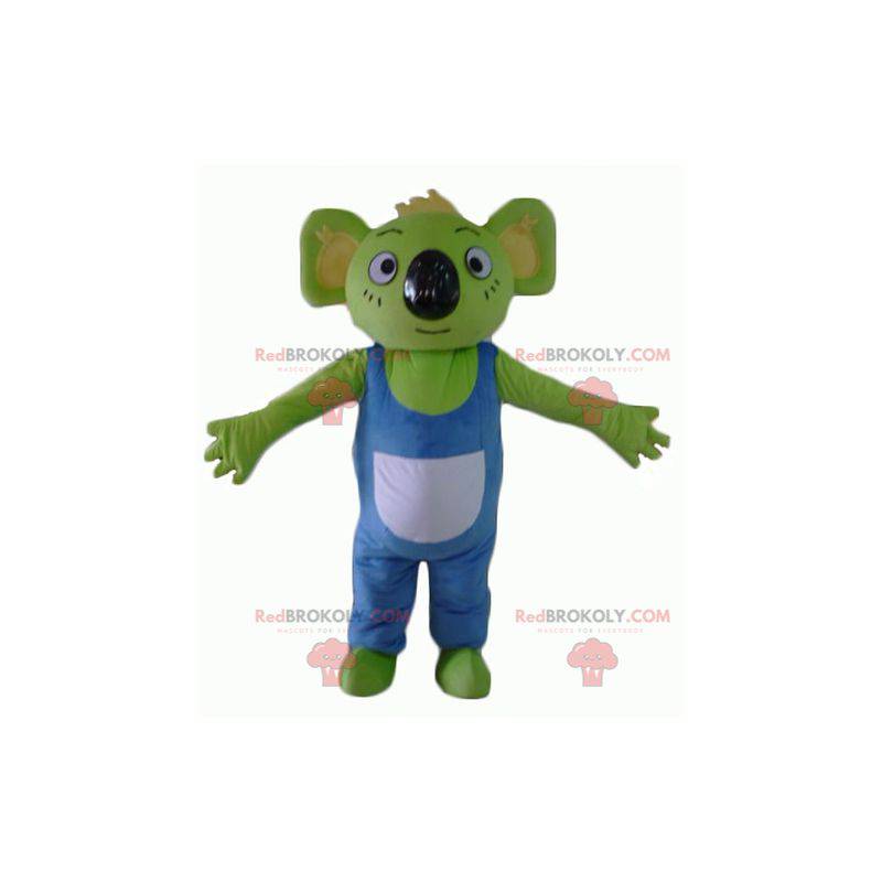 Mascota koala verde con overoles azules y blancos -