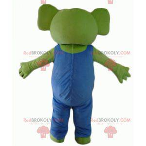 Mascota koala verde con overoles azules y blancos -