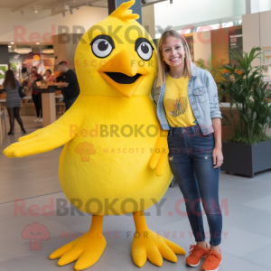 Yellow Blackbird mascot costume character dressed with a Mom Jeans and Suspenders