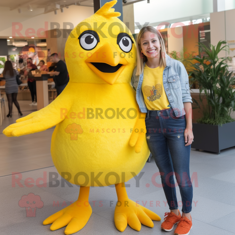 Yellow Blackbird mascot costume character dressed with a Mom Jeans and Suspenders Yellow Blackbird mascot costume character dressed with a Mom Jeans and Suspenders