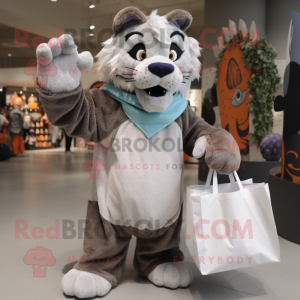 Gray Saber-Toothed Tiger mascot costume character dressed with a Cover-up and Tote bags