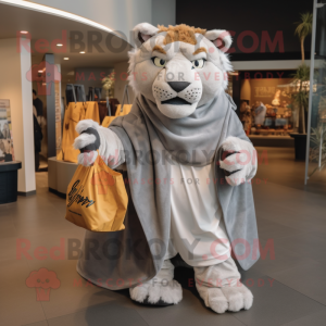 Gray Saber-Toothed Tiger mascot costume character dressed with a Cover-up and Tote bags