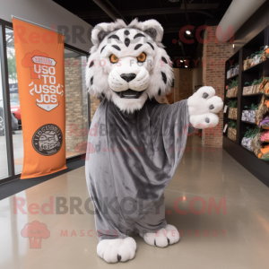 Gray Saber-Toothed Tiger mascot costume character dressed with a Cover-up and Tote bags