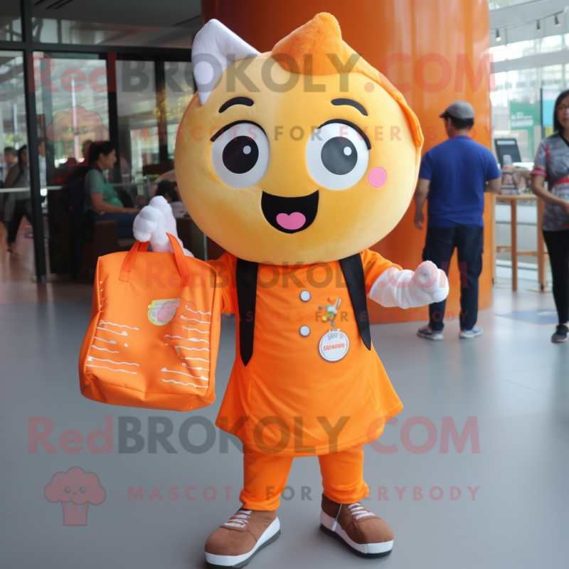 Orange Cupcake mascot costume character dressed with a Button-Up Shirt and Tote bags