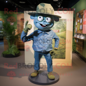 Olive Cyclops mascot costume character dressed with a Denim Shirt and Hat pins