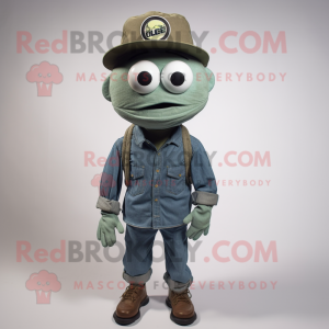 Olive Cyclops mascot costume character dressed with a Denim Shirt and Hat pins