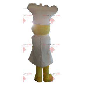 Mascote amarela com um avental e um chapéu branco -