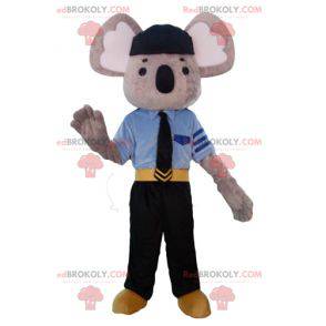 Mascota koala gris y blanco vestida con uniforme de policía -