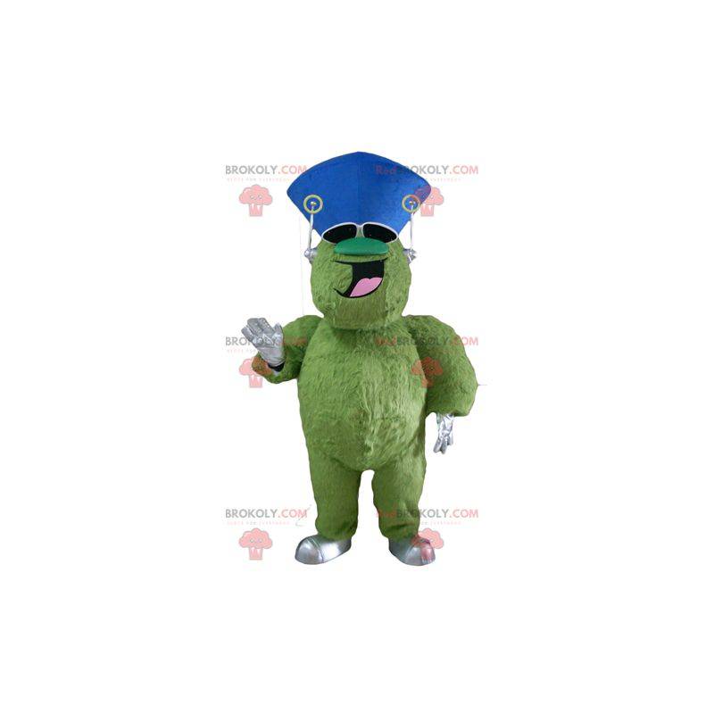 Mascote monstro verde peludo e gordo muito sorridente -