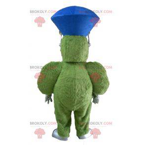 Mascote monstro verde peludo e gordo muito sorridente -