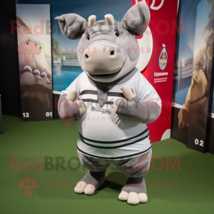 Silver Rhinoceros mascot costume character dressed with a Rugby Shirt and Shawls