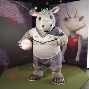 Silver Rhinoceros mascot costume character dressed with a Rugby Shirt and Shawls