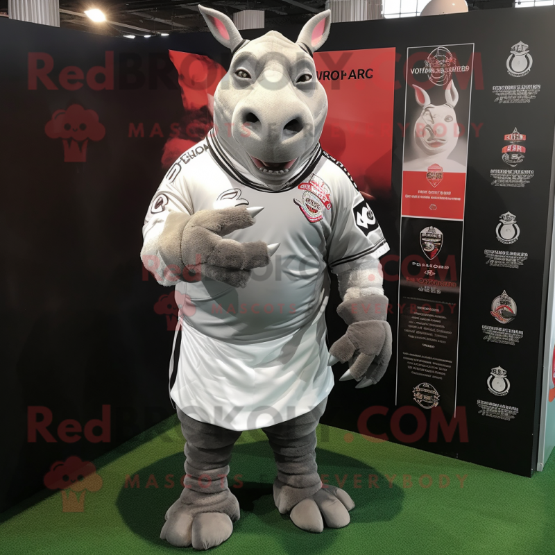 Silver Rhinoceros mascot costume character dressed with a Rugby Shirt and Shawls