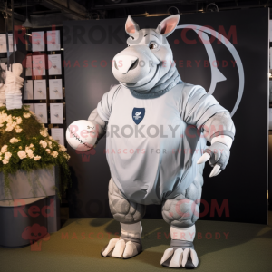 Silver Rhinoceros mascot costume character dressed with a Rugby Shirt and Shawls