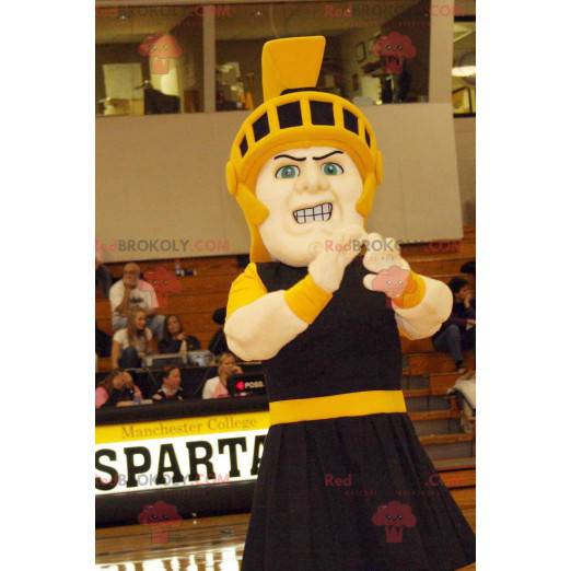 Knight mascot in black outfit with a yellow helmet -