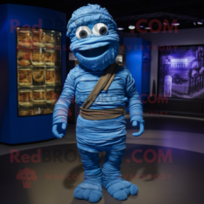 Blue Mummy mascot costume character dressed with a Overalls and Shoe clips