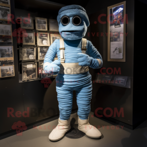 Blue Mummy mascot costume character dressed with a Overalls and Shoe clips