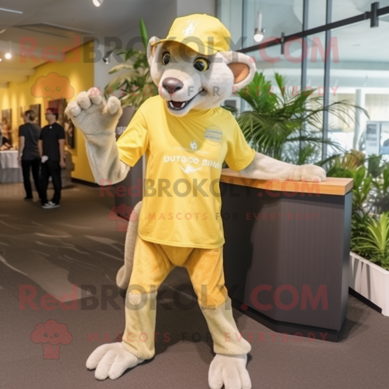 Lemon Yellow Thylacosmilus mascot costume character dressed with a Skinny Jeans and Caps Lemon Yellow Thylacosmilus mascot costume character dressed with a Skinny Jeans and Caps
