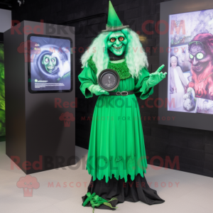 Green Witch mascot costume character dressed with a Shift Dress and Digital watches