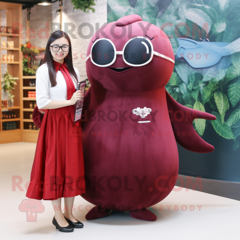 Maroon Narwhal mascot costume character dressed with a Dress and Eyeglasses Maroon Narwhal mascot costume character dressed with a Dress and Eyeglasses