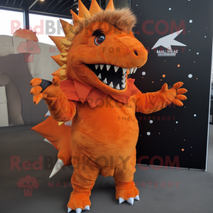 Orange Stegosaurus mascot costume character dressed with a Hoodie and Lapel pins