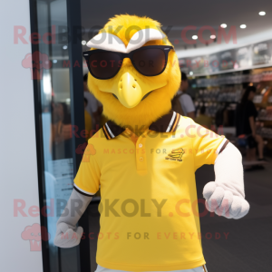 Yellow Falcon mascot costume character dressed with a Polo Tee and Reading glasses