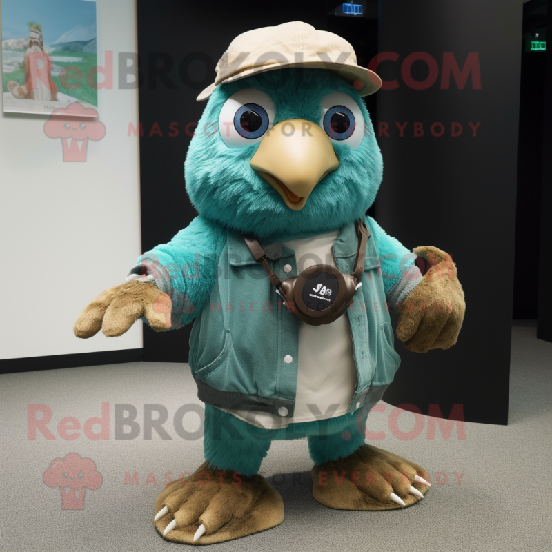 Teal Kiwi mascot costume character dressed with a Chinos and Keychains Teal Kiwi mascot costume character dressed with a Chinos and Keychains
