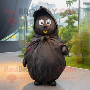 Black Potato mascot costume character dressed with a Raincoat and Wraps