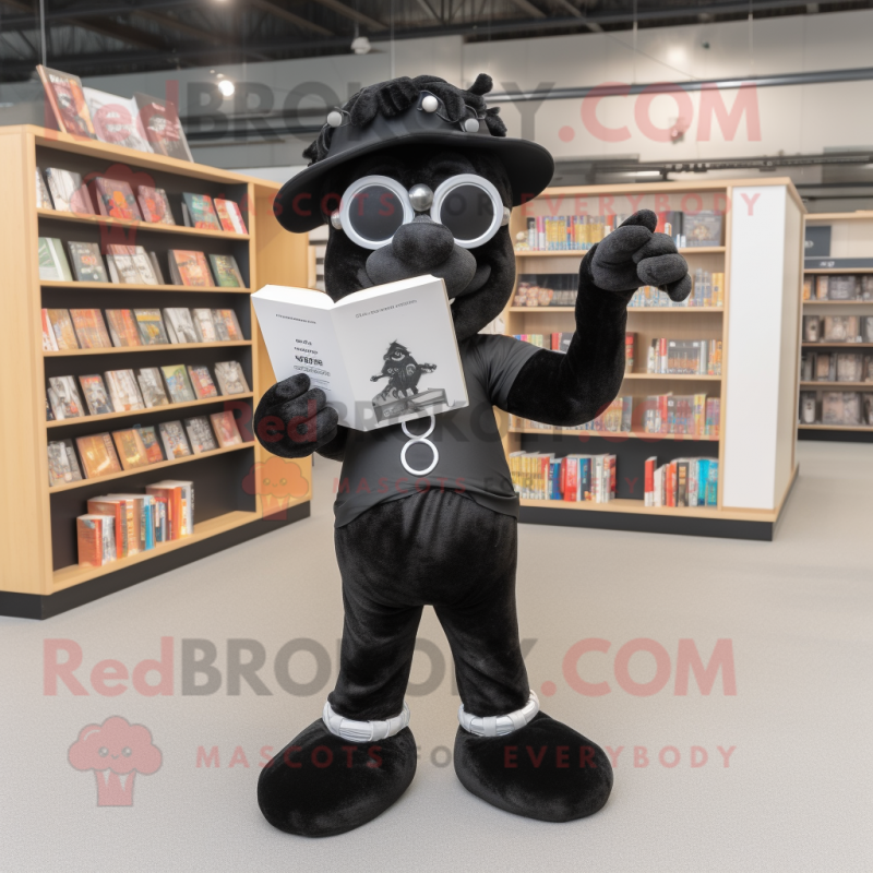 Black Horseshoe mascot costume character dressed with a Playsuit and Reading glasses Black Horseshoe mascot costume character dressed with a Playsuit and Reading glasses