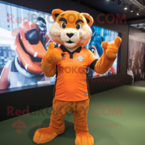 Orange Puma mascot costume character dressed with a Rugby Shirt and Gloves