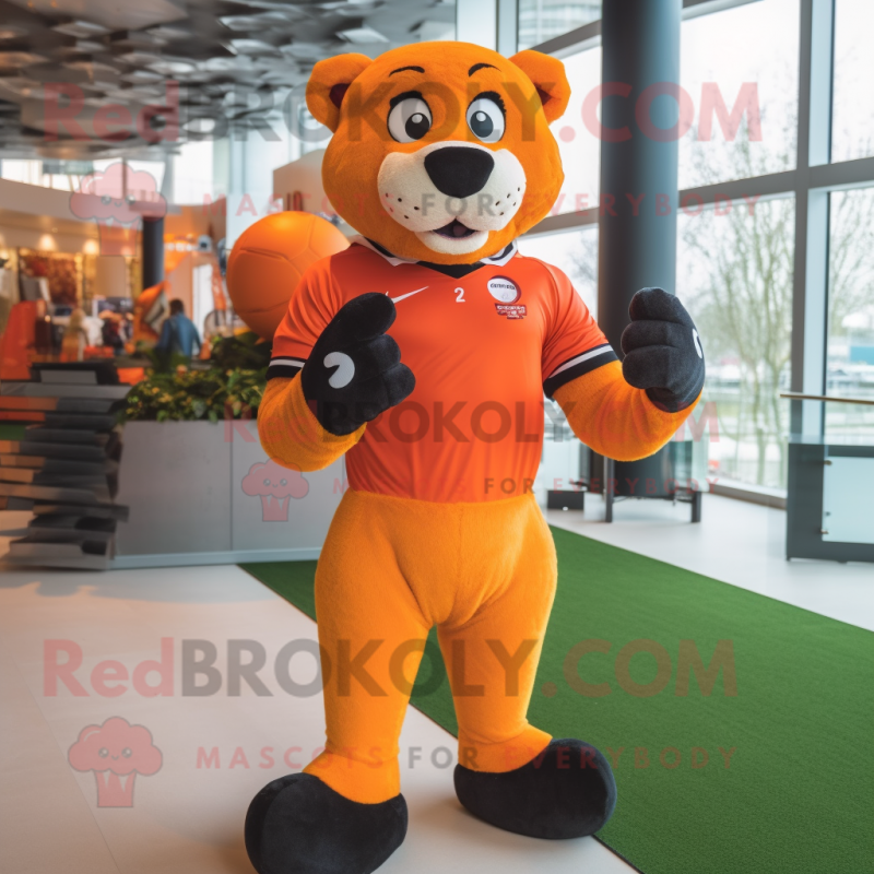 Orange Puma mascot costume character dressed with a Rugby Shirt and Gloves