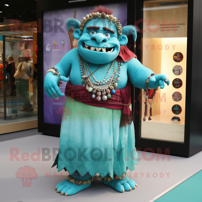 Turquoise Ogre mascot costume character dressed with a Maxi Skirt and Keychains Turquoise Ogre mascot costume character dressed with a Maxi Skirt and Keychains