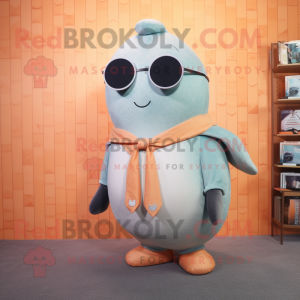 Peach Narwhal mascot costume character dressed with a Vest and Eyeglasses