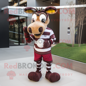 Maroon Okapi mascot costume character dressed with a Rugby Shirt and Mittens