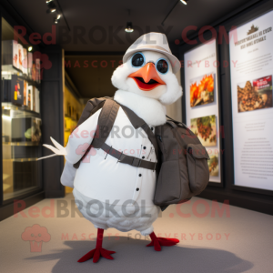 White Pheasant mascot costume character dressed with a Oxford Shirt and Messenger bags