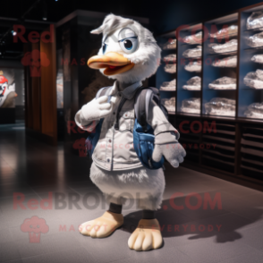 Silver Goose mascot costume character dressed with a Poplin Shirt and Backpacks