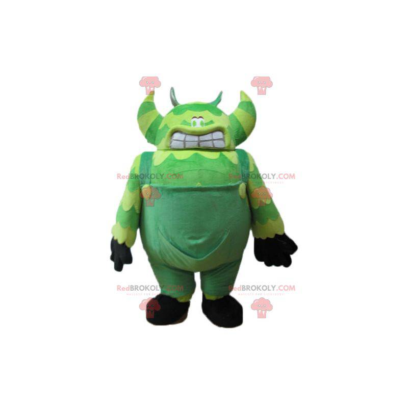 Mascot green monster in overalls very big and funny -