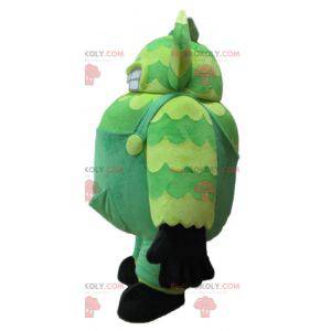 Mascotte de monstre vert en salopette très gros et rigolo -