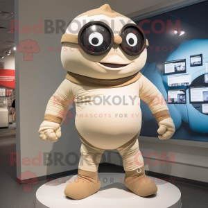 Beige Cyclops mascot costume character dressed with a Rash Guard and Ties