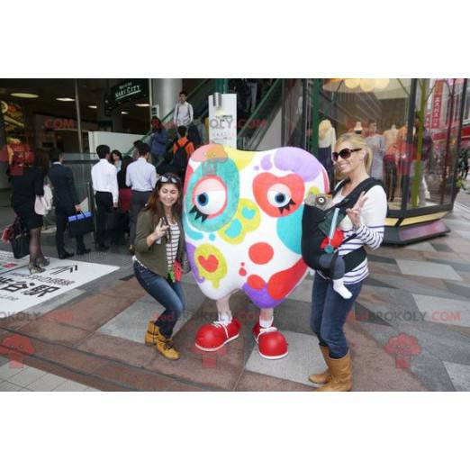 Mascota de diente blanco gigante manchada de colores -