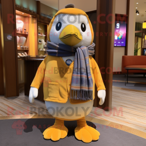 Gold Penguin mascot costume character dressed with a Oxford Shirt and Scarves