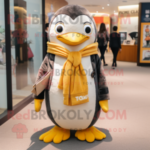 Gold Penguin mascot costume character dressed with a Oxford Shirt and Scarves