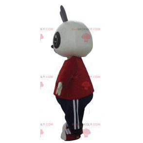 White and black rabbit mascot in red and black outfit -