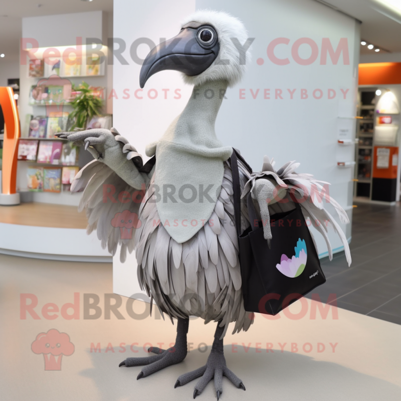 Silver Dodo Bird mascot costume character dressed with a Pencil Skirt and Tote bags