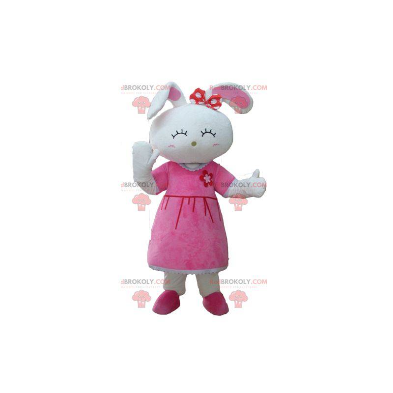 Leuk wit konijn mascotte gekleed in een roze jurk -