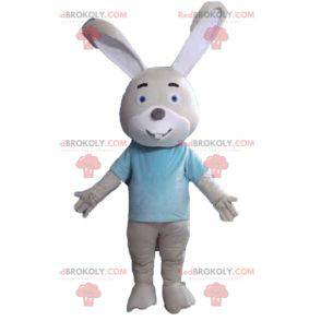 Beige and white rabbit mascot with a blue t-shirt -