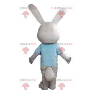 Beige and white rabbit mascot with a blue t-shirt -