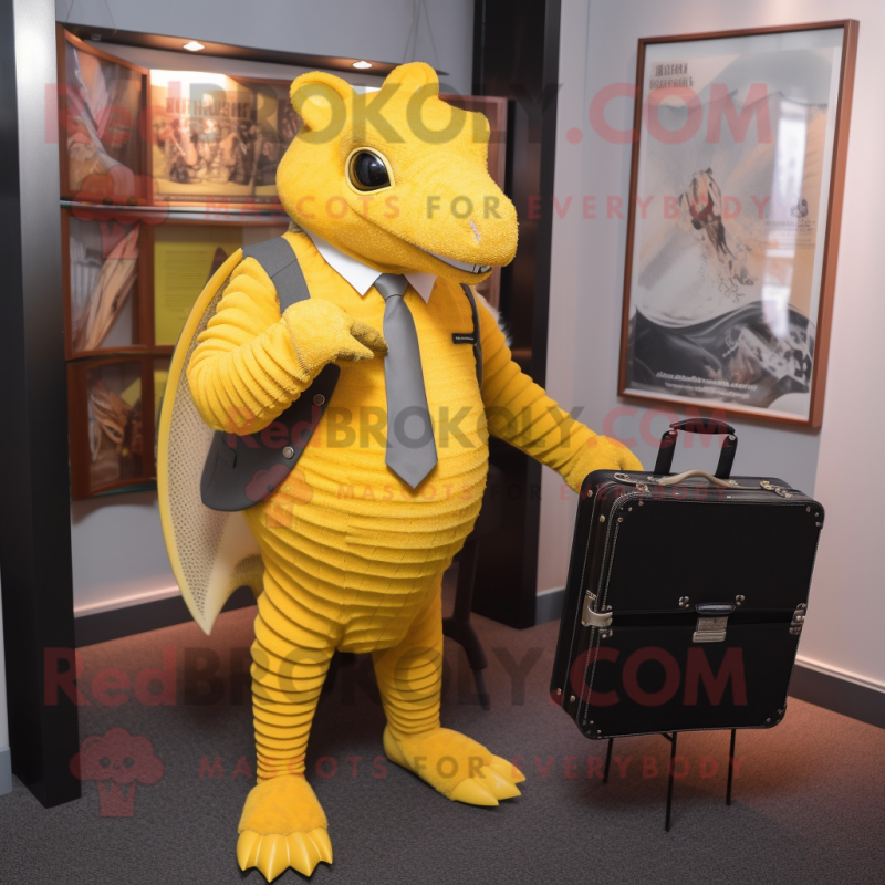 Yellow Armadillo mascot costume character dressed with a Suit Jacket and Briefcases